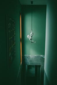 a green room with a table and a chandelier at BRICKS and BLOCKS MIYOTA in Miyota +139 photos
