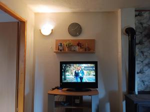 a television sitting on a table with a clock on the wall at Vlasic Relax in Vlasic +11 photos
