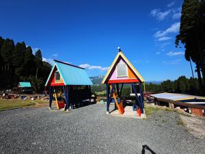 two small play structures on a gravel road at パワースポットキャンプ場 in Shimoda +7 photos