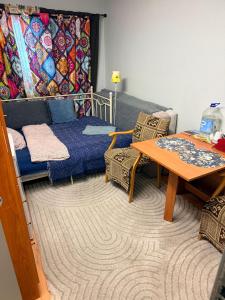 a living room with a bed and a table at Cosy room in Oslo