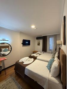 a hotel room with two beds and a mirror at Nomade Old City Hotel in Istanbul