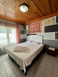 a bedroom with a large bed with a wooden ceiling at Delphin Apart Hotel in Side +95 photos