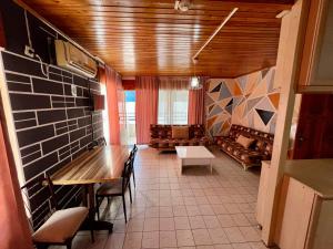 a living room with a table and a couch at Delphin Apart Hotel in Side