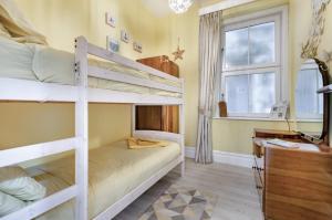a bedroom with two bunk beds and a window at Ocean view in Swanage