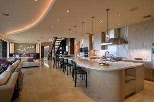 a kitchen with a bar and a living room at Magnificent Oceanfront West Maui in Lahaina
