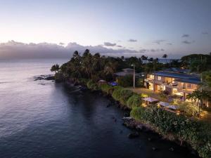 an aerial view of a house next to the water at Magnificent Oceanfront West Maui in Lahaina