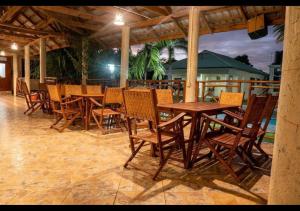 a restaurant with wooden tables and chairs on a patio at Paradiso Hotel in Dar es Salaam