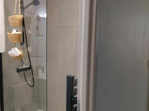 a bathroom with a shower with a glass door at Le patio de la place in Saint-André-de-Sangonis +20 photos