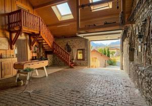a large room with a staircase and a piano at Le Rocher des Ducs, Chambres d'hôtes, parking privé, abris motos in Le Glaizil