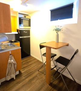a small kitchen with a table and chairs in it at Small cozy basement apartment in Sundsvall