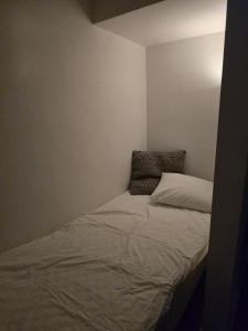 a small bedroom with a bed in the corner at Small cozy basement apartment in Sundsvall
