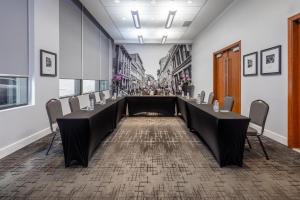 a conference room with a long table and chairs at Embassy Suites by Hilton - Montreal in Montreal