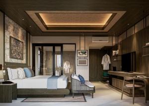 a bedroom with a large bed and a desk at The Sankara Hill Penida in Sampalan