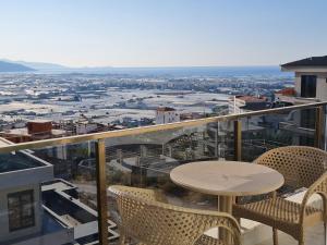 a table and chairs on a balcony with a view at Hillfort Suites Apart Otel in Demre +32 photos