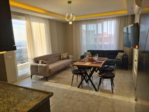 a living room with a table and a couch at Hillfort Suites Apart Otel in Demre