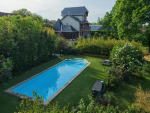 an aerial view of a yard with a swimming pool at Chambres de charme avec piscine - Le Monde de Charlie - Proche Vichy in Vichy