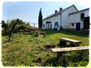 a building with a bench in front of it at Chalupa nad Dvorem in Slezské Pavlovice +17 photos