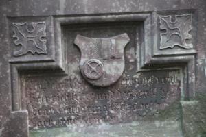 a stone wall with a symbol on it at Ferienwohnung Mühlradblick in Geismar +63 photos
