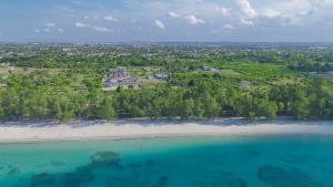 an aerial view of a beach with trees and blue water at Geza Breeze Residence in Kigamboni