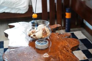 a glass bowl of food on a wooden table at Geza Breeze Residence in Kigamboni
