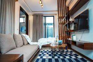 a living room with a couch and a table at Geza Breeze Residence in Kigamboni