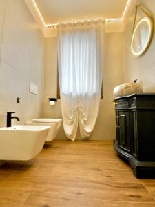 a bathroom with a sink and a toilet and a tub at Romantic suite between Venice and Padua in Dolo +6 photos