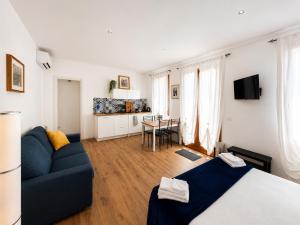 a living room with a bed and a blue couch at Romantic suite between Venice and Padua in Dolo