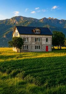 a house in a field with mountains in the background at LiLi Boutique in Dsegh