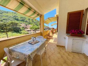 a table and chairs on a balcony with a view at Ammiraglio in Campese