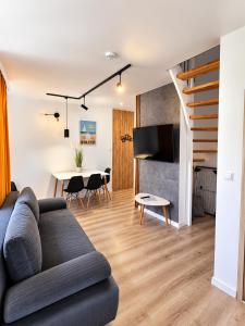 a living room with a couch and a table at Sunrise Marina Domki Mielno- Ferienhaus in Mielenko
