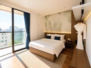 a bedroom with a bed and a large window at One Studio Suite by PSH in Krong Poi Pet