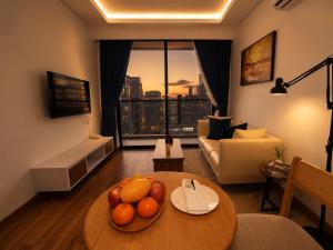 a living room with a bowl of fruit on a table at One Studio Suite by PSH in Krong Poi Pet +27 photos