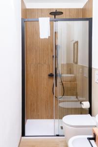a bathroom with a shower with a toilet and a sink at Casa Matilde Rooms & Apartment in Bazzano Bologna