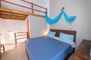 a bedroom with a blue bed with a blue drape at Michaella's Maissonete at Rafaella Resort in Kokóni +14 photos