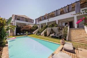 a swimming pool in the backyard of a house at Michaella's Maissonete at Rafaella Resort in Kokóni