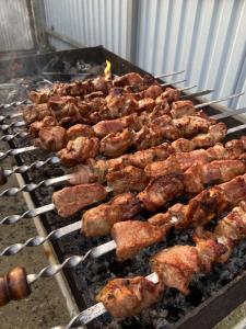 a bunch of food cooking on a grill at Abylay Guesthouse in Jangy-Talap