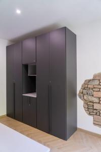 a black wardrobe in a room with a wall at Casa Matilde Rooms & Apartment in Bazzano Bologna