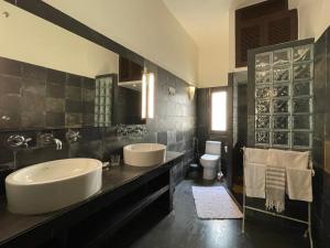 a bathroom with two sinks and a toilet at Zaza Stay in New Delhi +69 photos