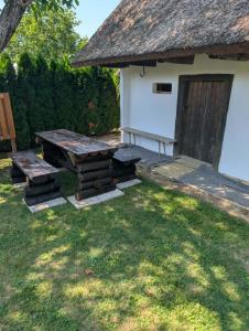 a picnic table and a bench next to a building at Hrgova hiška in Vitomarci