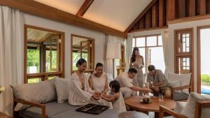 a group of people sitting in a living room at Siritarar Residence by Elite Havens in Nathon Bay