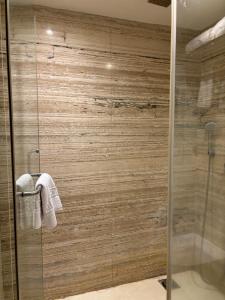 a bathroom with a shower with a glass door at Ramee Guestline Hotel Khar in Mumbai +34 photos