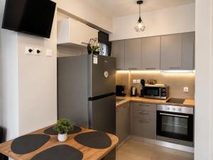 a kitchen with a stainless steel refrigerator and a wooden table at Aelia Blu 2 Maisonette in Ofrínion