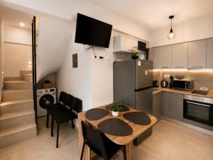a kitchen and dining room with a table and a refrigerator at Aelia Blu 2 Maisonette in Ofrínion +12 photos
