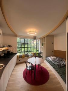 a kitchen and dining room with a table and a bed at Karlštejn 34 in Karlštejn