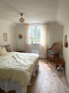 a bedroom with a large bed and a window at Mysigt torp Cozy Cottage in Tranås