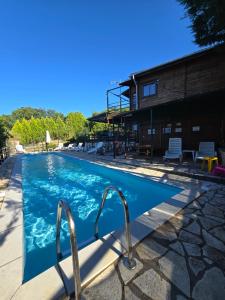 a swimming pool with blue water in a building at Zeus-village Chalet με πισίνα in Mólos