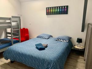 a bedroom with a bed with a stuffed animal on it at Au Ptit MARIUS in Fécamp