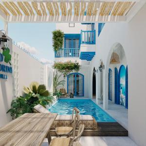 a villa with a pool and a table and chairs at TD Santorini Pool Villa in Cổ Lưu (1)
