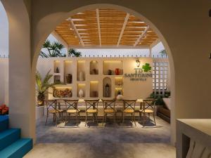 a dining room with a table and chairs at TD Santorini Pool Villa in Cổ Lưu (1)
