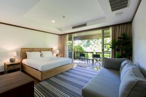 a bedroom with a bed and a couch at Katamanda Aliya Pool & Jacuzzi Villa Kata in Kata Beach +76 photos